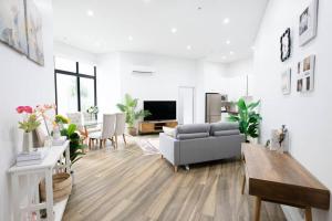 a living room with a couch and a table at Cozy Retreat in Sydney CBD in Sydney
