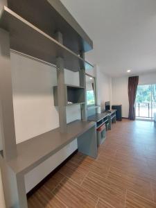 an empty room with a desk and shelves at Sisina Resort in Ban Krut