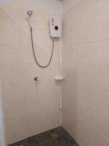 a shower in a bathroom with a blow dryer on the wall at Sisina Resort and Spa in Prachuap Khiri Khan