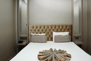 a bedroom with a large bed with a star decoration on it at Enerji Otel in Ankara