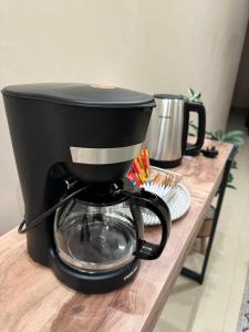 a black coffee maker sitting on top of a table at شقق نسج المسكن دخول ذاتي شمال الرياض in Riyadh
