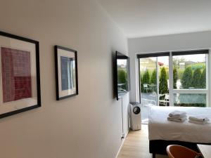 sypialnia z łóżkiem i 3 zdjęciami na ścianie w obiekcie CPH Like Home w Kopenhadze