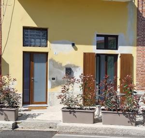 a house with three potted plants in front of it at LaCasetta in Burago di Molgora