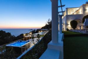 a villa with a swimming pool and the ocean at Dimora Maiuri L'Olivella in Anacapri