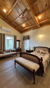 a bedroom with a bed and a couch in a room at The Magnolia Lodge in Almora