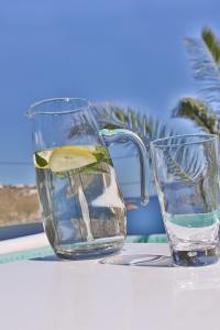 a pitcher and a glass of water on a table at Villa Athena by Elite Estates in Agios Ioannis Mykonos