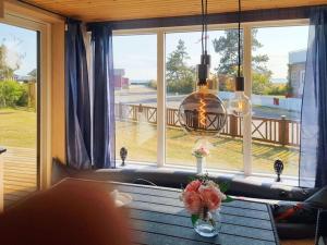 a table with flowers on it in front of a window at Beach/Marina House in Nørreby
