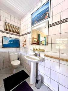 a bathroom with a sink and a toilet at Meri Lodge Huahine « ROOM OF MARTA » in Fare