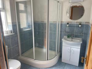 a bathroom with a shower and a sink at The Anglesea - 8 Bedroom with Parking in Southampton