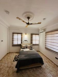 um quarto com 2 camas e uma ventoinha de tecto em Best Apartment em Adentan