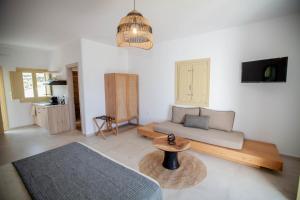 a living room with a couch and a table at Agathia Resort in Schinoussa