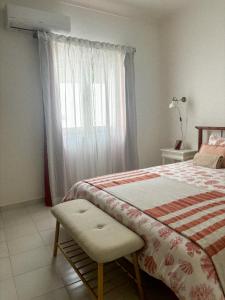 a bedroom with a bed and a window at Casa Pérola, Old Town Apartment in Albufeira