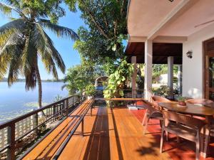 a house with a balcony with a view of the ocean at Myh Lake Front Pvt Villa with Staff, Near City, Inc Free Breakfast in Bandaragama
