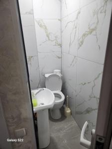 a bathroom with a toilet and a sink at Hostel Highway in Samarkand
