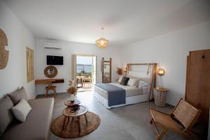 a living room with a bed and a couch at Agathia Resort in Schinoussa