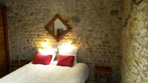 a bedroom with a bed with a mirror on the wall at Le Grangeon 01 in Ambérieu-en-Bugey