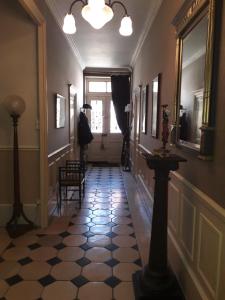 a hallway with a black and white tile floor at La Belle Epoque in Époisses
