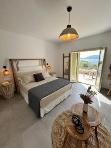 a bedroom with a large bed and a table at Agathia Resort in Schinoussa +76 photos