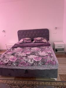 a bedroom with a bed with a pink wall at Exclusive apartments Visoko 2022 in Visoko
