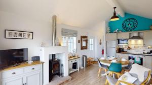 a kitchen and living room with a table and chairs at Salty Dog at The Bay Filey, sleeps 4, 2 dogs welcome for free too in Filey
