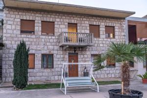 a building with a chair in front of it at Apartman GIF in Trebinje