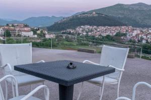 a table and chairs with a view of a city at Apartman GIF in Trebinje +2 photos