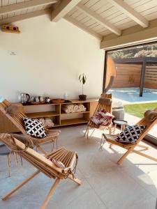 a living room with rocking chairs and a table at Agriturismo Il Cucchiaio di Legno in Orta San Giulio