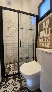 a bathroom with a toilet and a sign that says do what you love every day at Athena Tiny House in Bodrum City