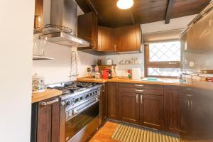 a kitchen with wooden cabinets and a stove top oven at A casa di Fio' in Trevignano Romano