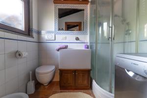a bathroom with a toilet and a sink and a shower at A casa di Fio' in Trevignano Romano