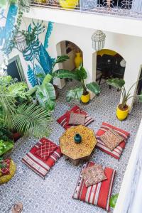 a doll house with furniture and plants on a shelf at Dar Didifa in Marrakesh