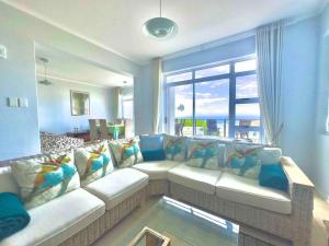 a living room with a couch and a window at Luxury at Fynbos 5 in Mossel Bay +18 photos
