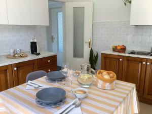 a kitchen with a table with plates and bowls of food at La Casa Gialla in Scardovari