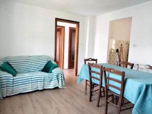 a living room with a table and a couch at Maison Dayné - DimoraAlpina in Introd