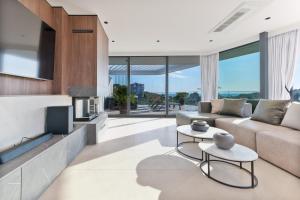 a living room with a couch and a tv at Villa Isola in Murter