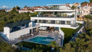 an aerial view of a house with a swimming pool at Villa Isola in Murter