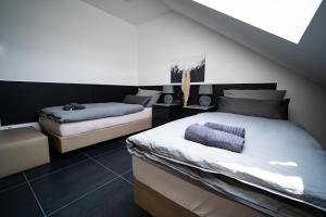 a bedroom with two beds and a staircase at Blauer Stein Apartments WH5 in Pulheim