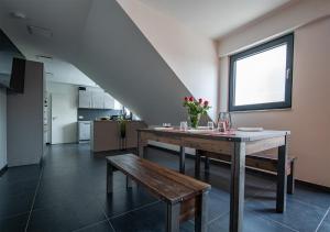 a dining room with a table and a bench at Blauer Stein - Echo WH05 - Penthouse in Pulheim