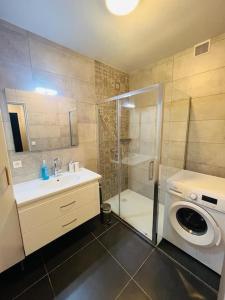 ein Bad mit einer Dusche und einer Waschmaschine in der Unterkunft Appart T4 85m2 spacieux climatisation parking in Rodez