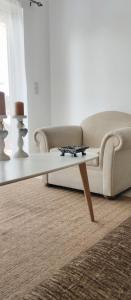 a living room with a couch and a coffee table at Lovely Place in Akharnaí