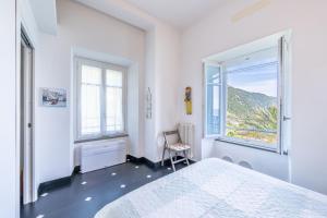 a white bedroom with a bed and a window at NEW 2024 Hanging Garden in Corniglia