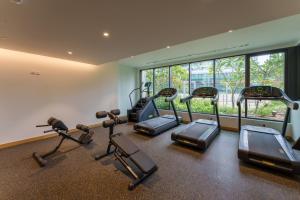 a gym with a bunch of cardio equipment in it at Luxury Redefined in AHAD Residence by Suiteable in Dubai