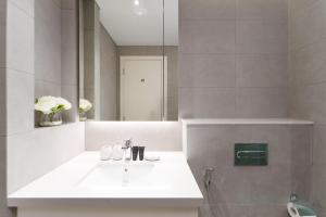 a bathroom with a sink and a mirror at Luxury Redefined in AHAD Residence by Suiteable in Dubai