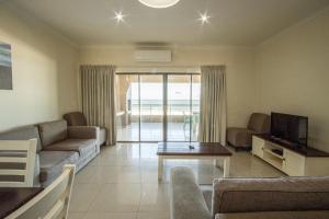 a living room with a couch and a tv and a table at Saints View Resort Unit 16 in Uvongo Beach