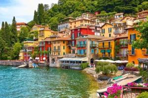 a group of colorful houses next to a river at Appartamento tra lago&montagna in Taceno