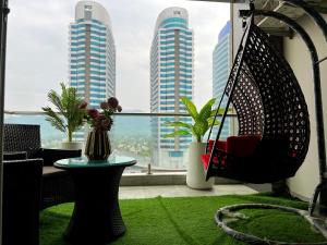 a room with a hammock and a window with buildings at Centaurus Facing Executive Apartments By Elysium Tower Islamabad in Islamabad