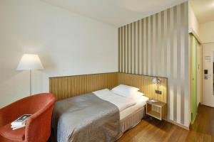 A bed or beds in a room at Sorell Hotel Rütli
