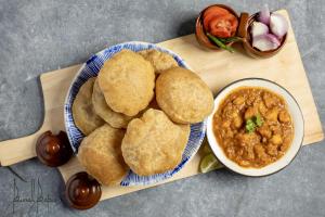 a plate of food with biscuits and a bowl of dips at The Grand Mansion Hotel in Greater Noida
