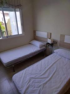 Cama ou camas em um quarto em Casa adosada en Daimus solo para familias