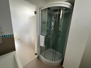 W łazience znajduje się prysznic ze szklanymi drzwiami. w obiekcie Lo Scalo 2.0 w mieście Marina di Ragusa